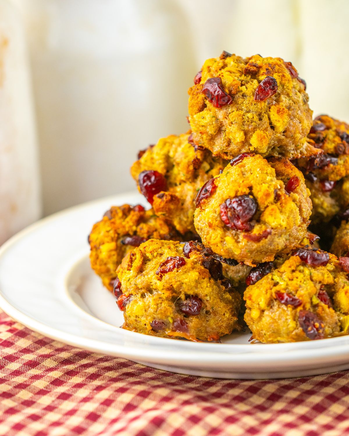A stack of cranberry turkey stuffing balls on a white plate.