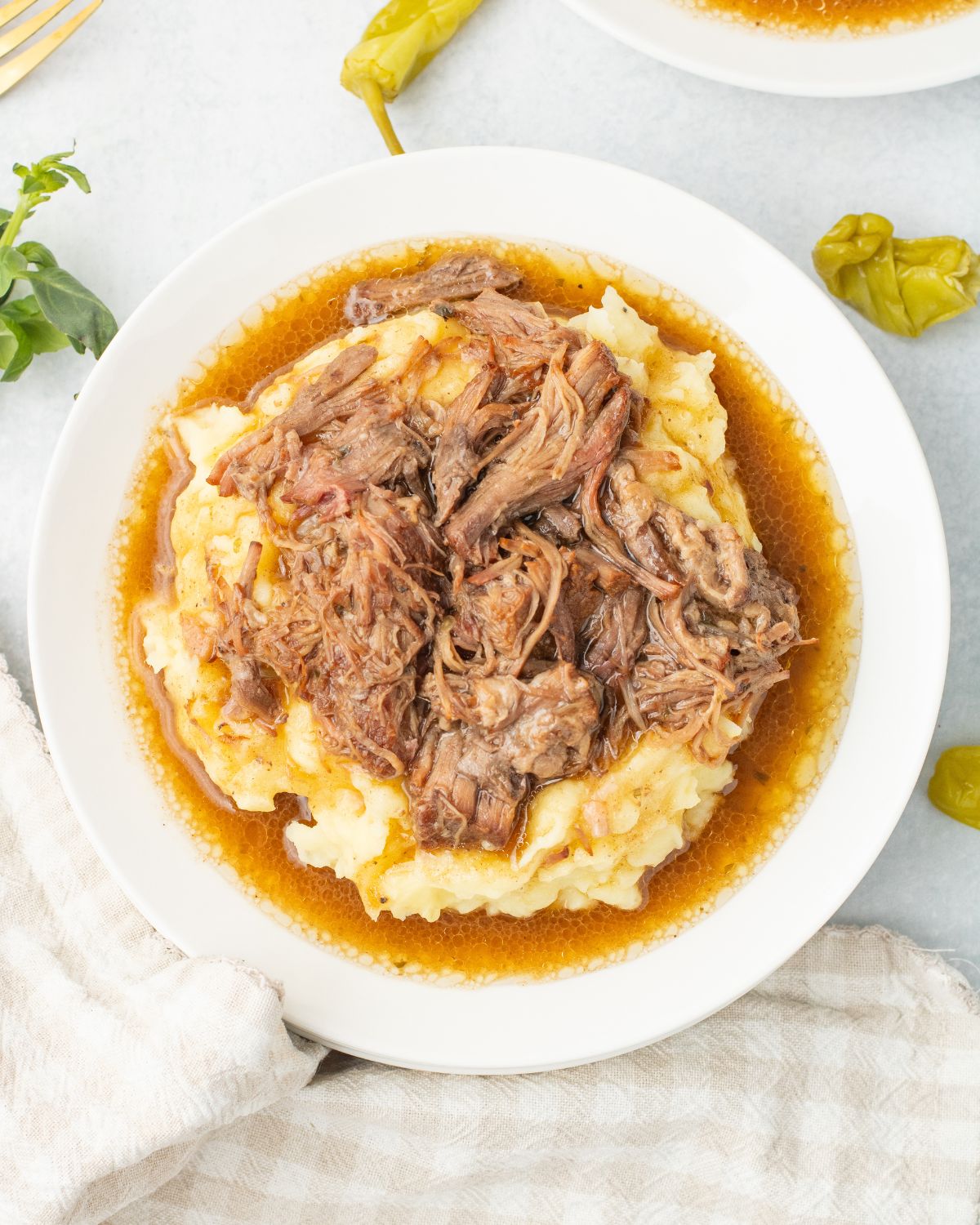 Instant pot Mississippi roast served with mashed potatoes on a white plate.