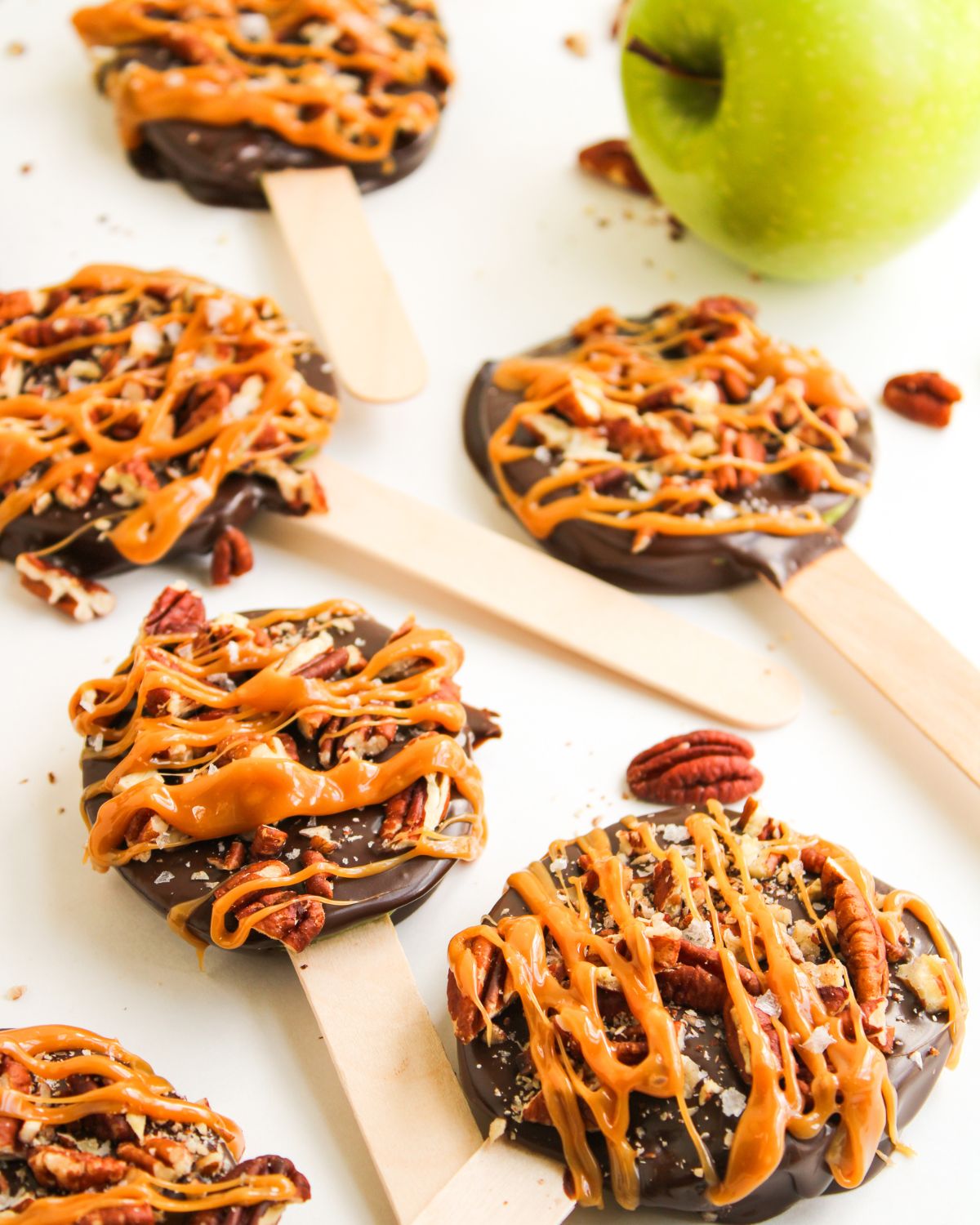 Apple slices dipped in chocolate with pecans and drizzled caramel.