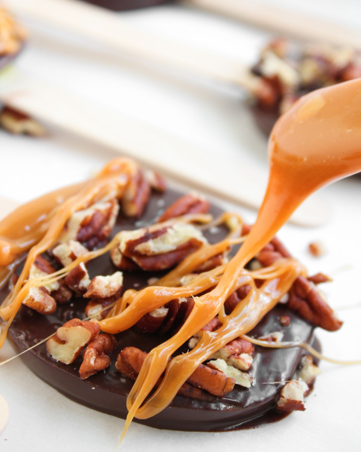 Apples topped with chocolate, caramel, and pecans.