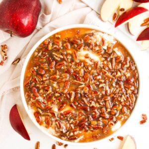 No Bake Pecan Pie dip in a whote bowl with apples on the side.