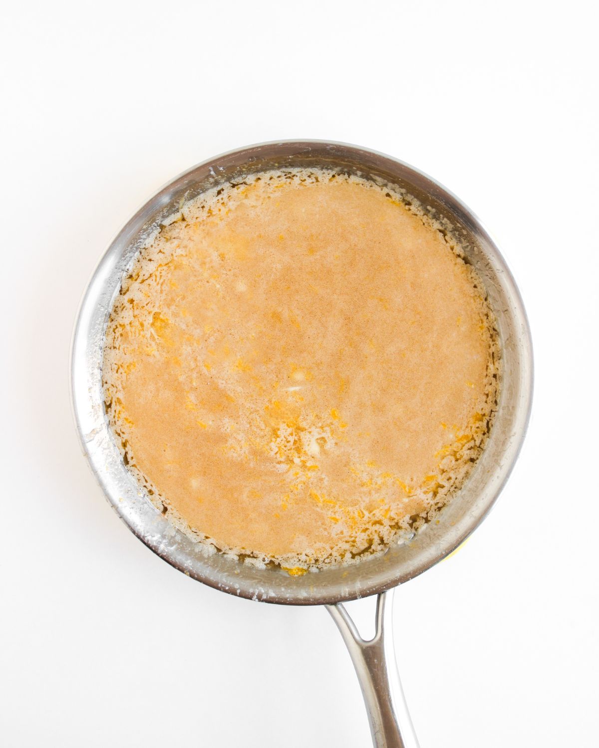 A sauce pan with caramelized butter to make pumpkin pie dip.