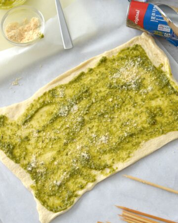 Crescent Dough Topped with pesto to make Christmas tree appetizers.