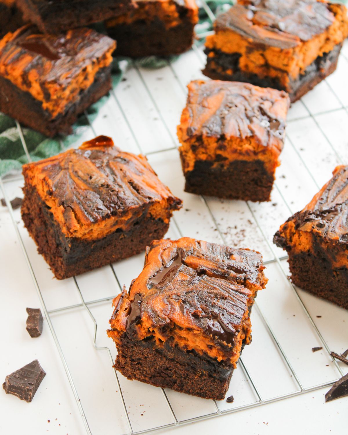 Pumpkin Cream cheese swirl brownies sliced on a cooling rack.