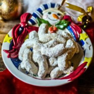 Pecan crescents on a snowman cookie plate.