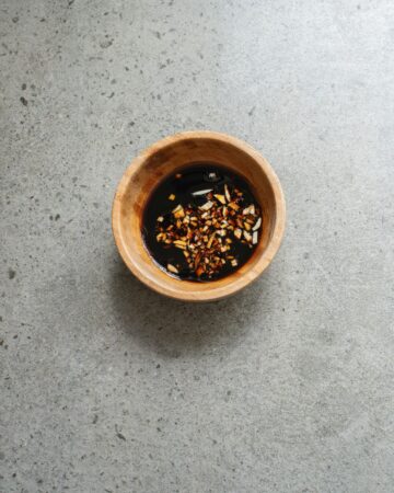 Homemade Teriyaki Sauce being made in a wooden bowl for teriyaki chicken bowls.