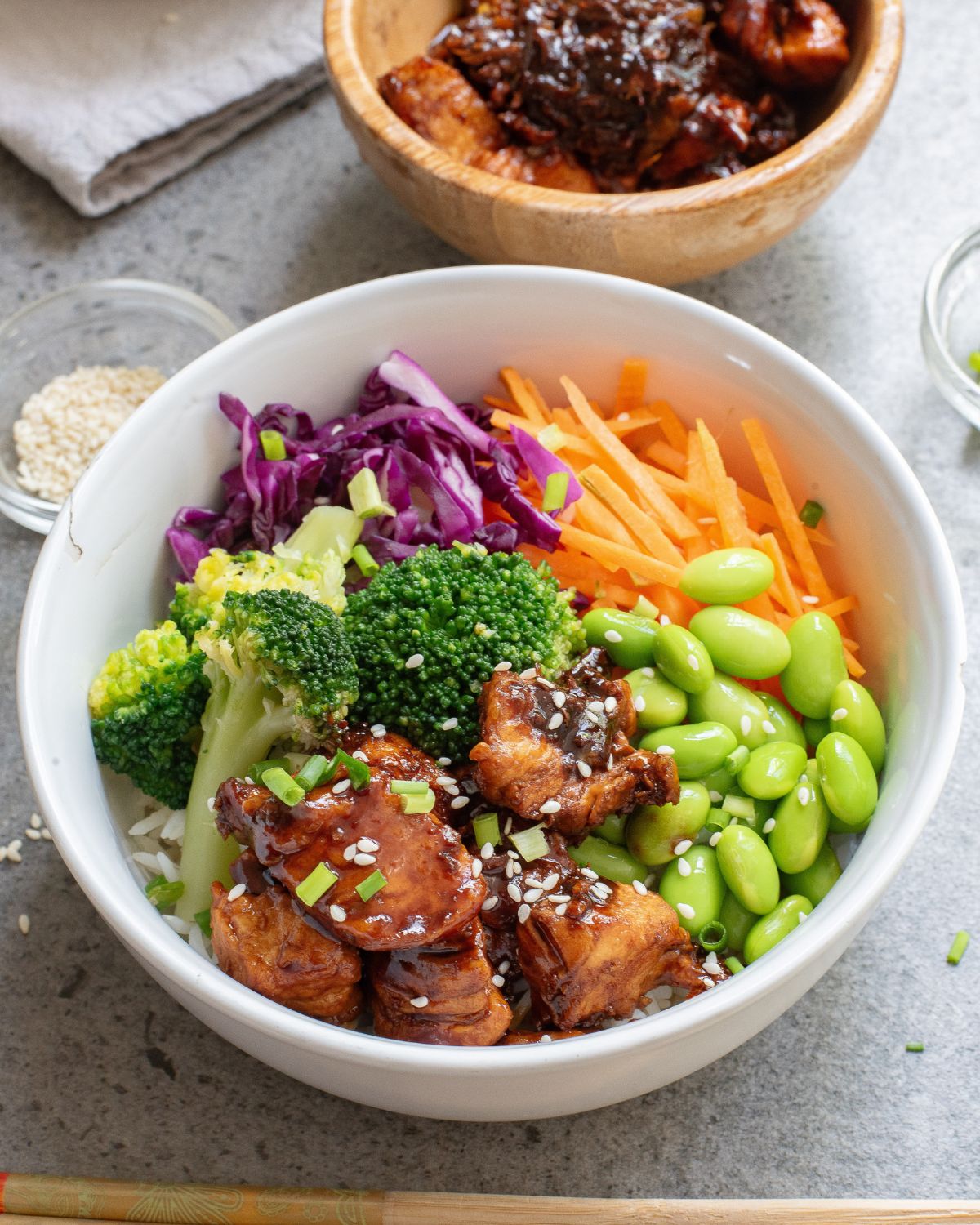 Teriyaki chicken rice bowls with chicken, broccoli, carrots, and red cabbage.