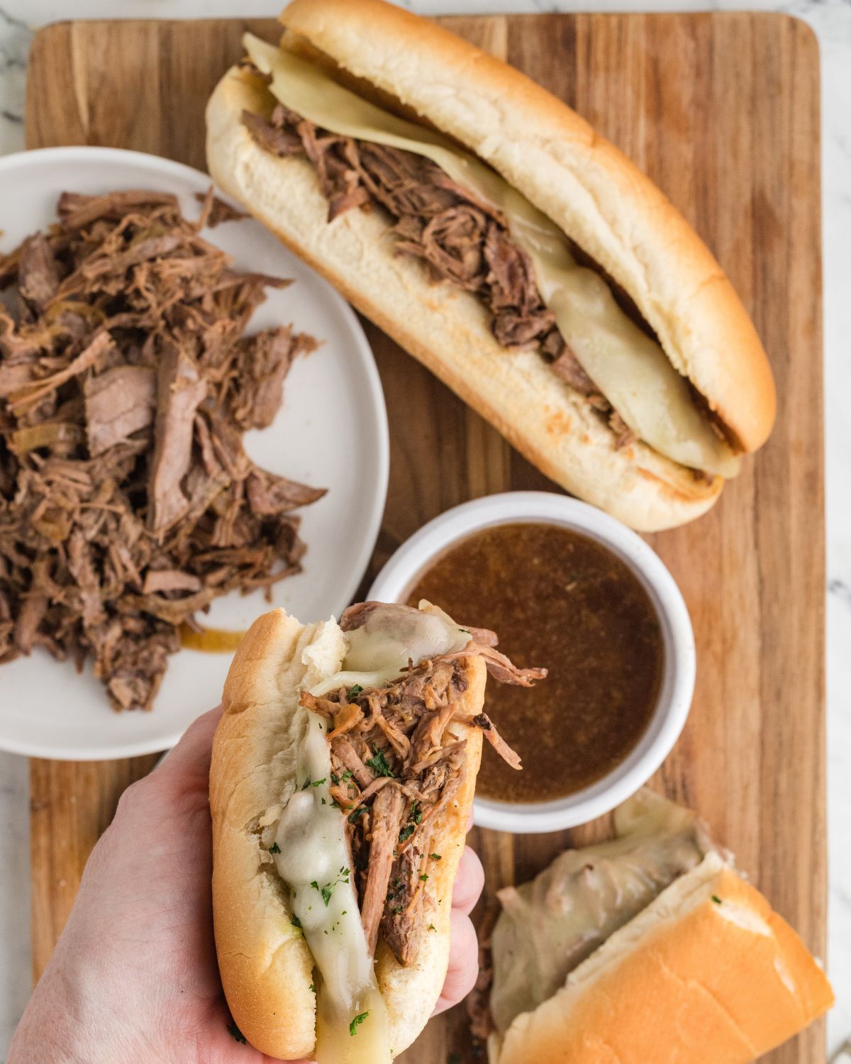 A slow cooker french dip sandwiches with homemade au jus. 