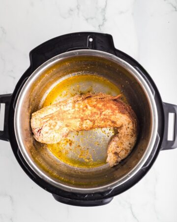 A pork tenderloin browned in an instant pot.