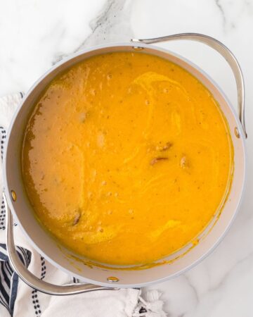 A soup pot of Cauliflower Sweet Potato Soup with Andouille sausage.