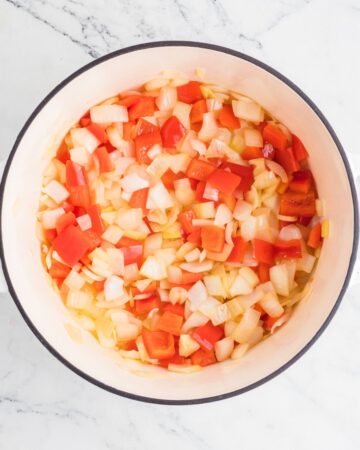 Diced onions and red peppers to make the base of chili cheese mac and cheese.