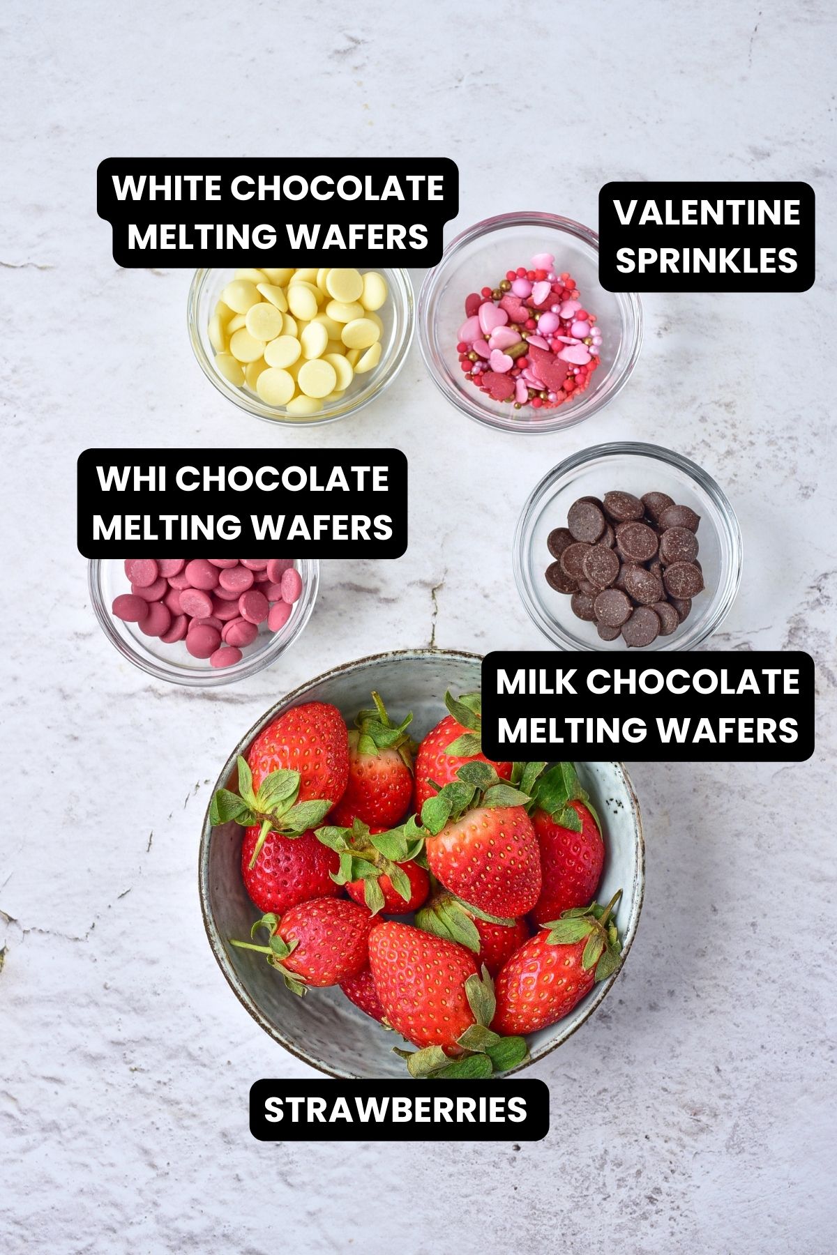 Ingredients to make chocolate covered strawverries with melting chocolates and sprinkles.