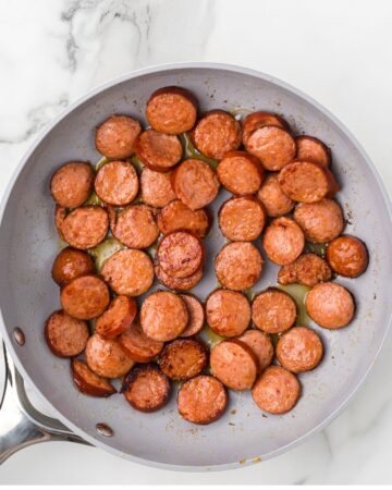 Sliced andouille sausage to make a cauliflower and sweet potato soup recipe.