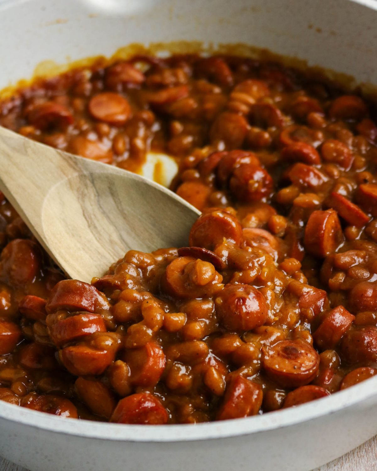A skillet with beanie weenies which is beans and franks.