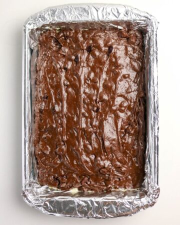 The brownie batter for cherry chocolate brownie in a 9 x 13 pan.