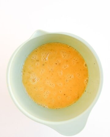 A mixing bowl with eggs to make breakfast sliders.