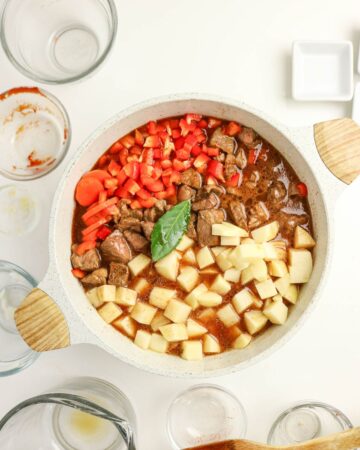 Ingredients in a Dutch oven to make Hungarian Goulash Stew.