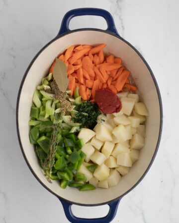The ingredients needed for manhattan clam chowder in a Dutch Oven.