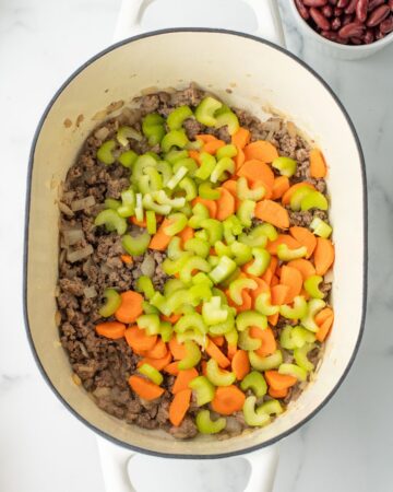 The makings of pasta e fagioli recipe with celery, carrots, and ground beef.