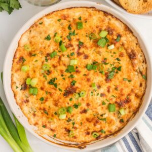 Hot Crab Dip made with lump crab meat and sour cream in a baking dish.