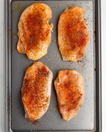 Boneless chicken breasts with a dry rub to be baked in the oven.