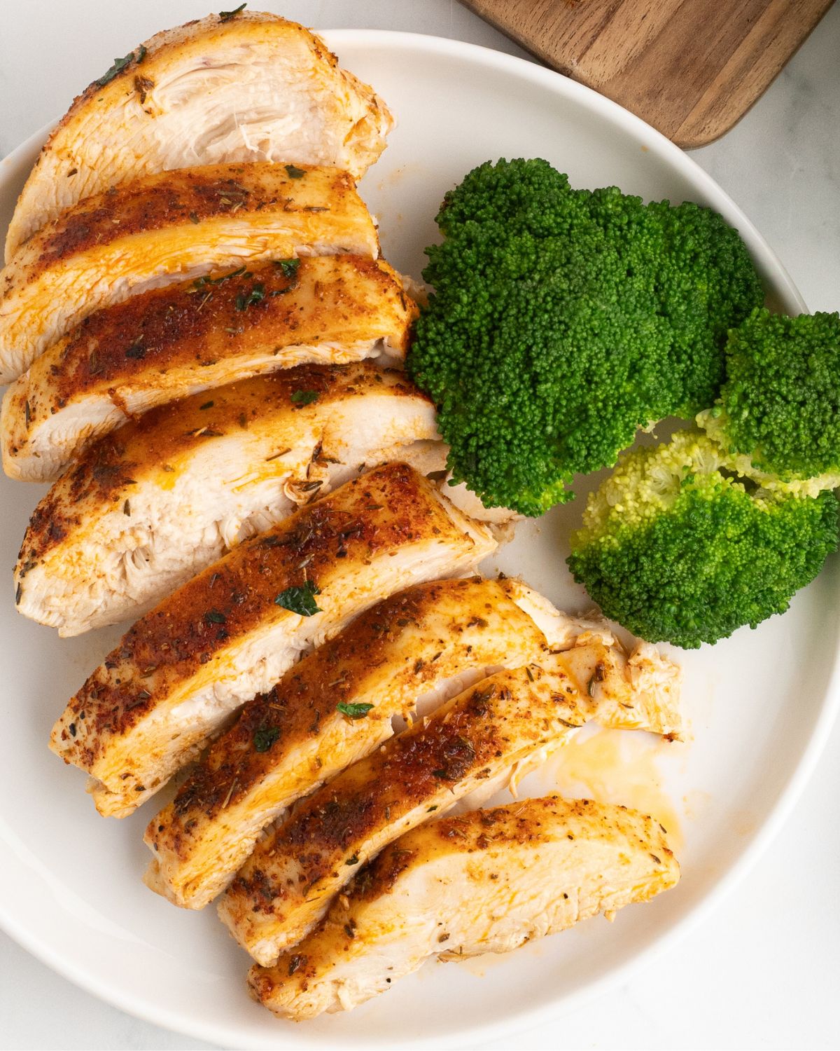 Baked Chicken Breasts with broccoli on a plate.