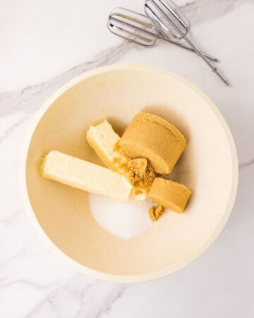 Butter, brown sugar, and granulated sugar in a mixing bowl to make brown butter chocolate chip cookies.