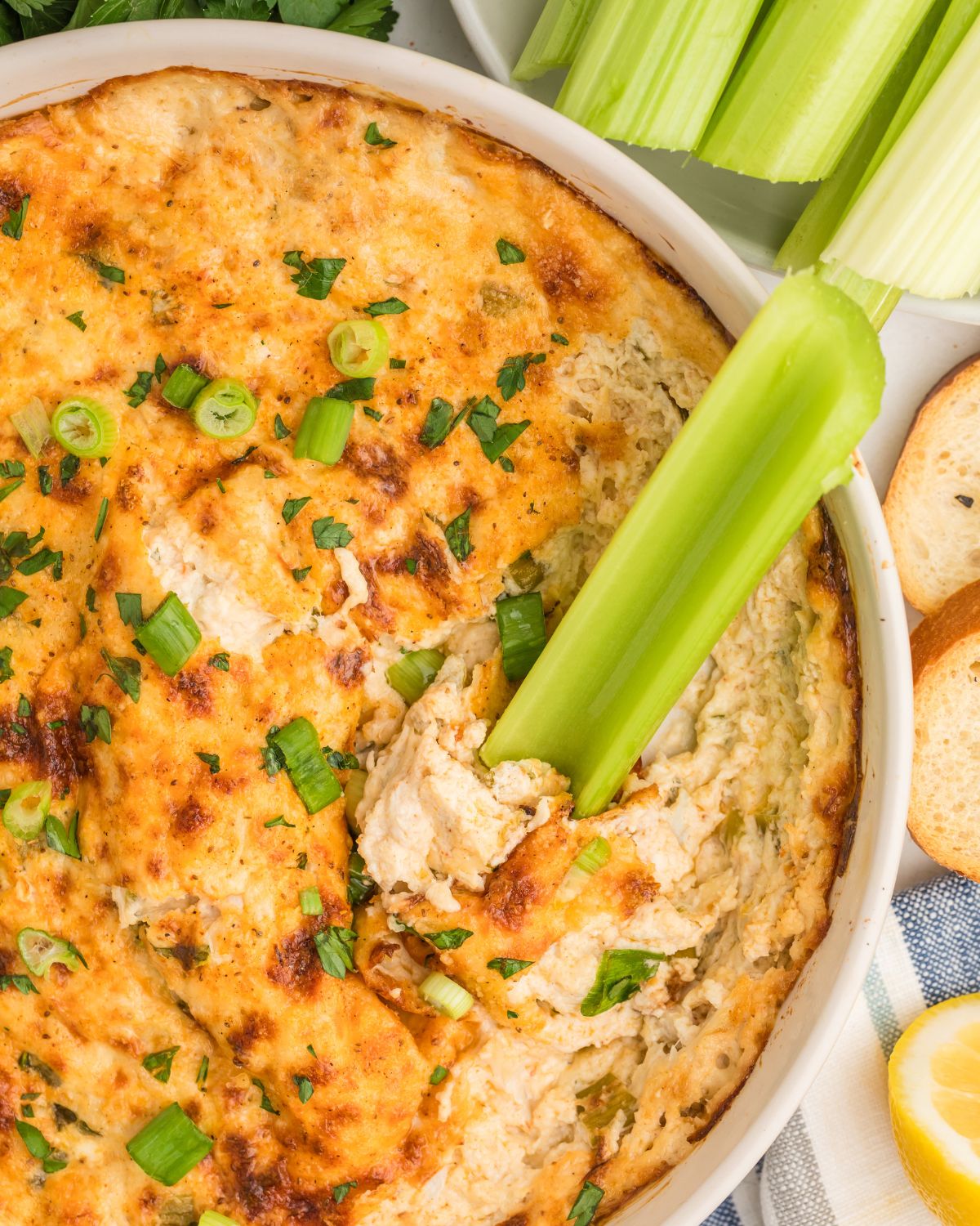 Crab meat hot dip with celery in the dip.