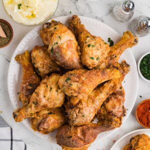 Crispy baked chicken legs in a plate.