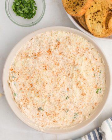 A white bake dish with the best hot crab dip ready to be baked.