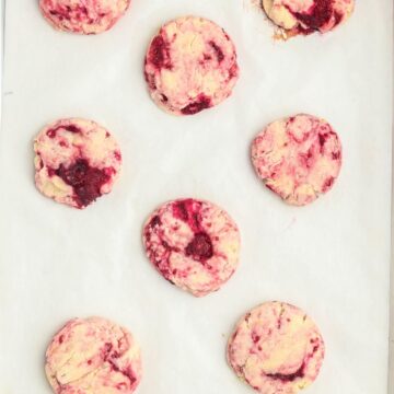 Baked lemon raspberry cookies on a baking sheet.