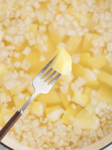 Fork tender potatoes in a dutch oven to make potato salad, no eggs.