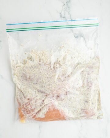 Grilled chicken gyro marinade with the yogurt based marinade and chicken in a resealable bag.