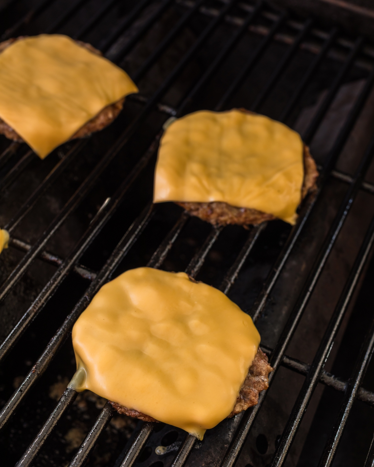 Grilled frozen burgers on the grill.