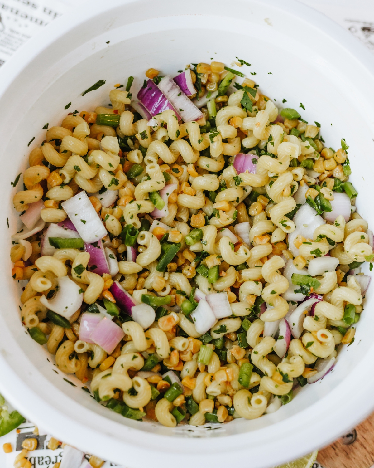 A large mixing bowl with the ingredients to make Mexican Street Corn Chicken Salad.
