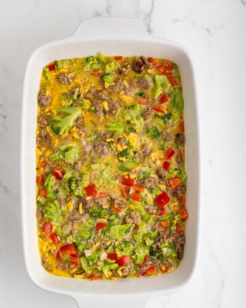 A cheesy egg broccoli casserole in a casserole dish.