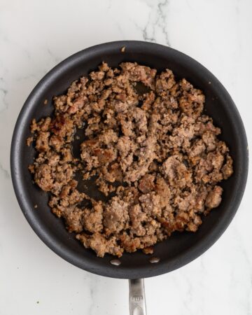 Ground breakfast sausage browned in a sauté pan.
